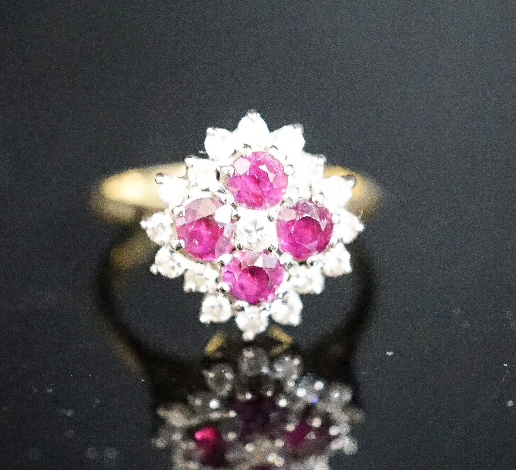 A modern 18ct gold, ruby and diamond cluster ring, size M, gross weight 4.2 grams.